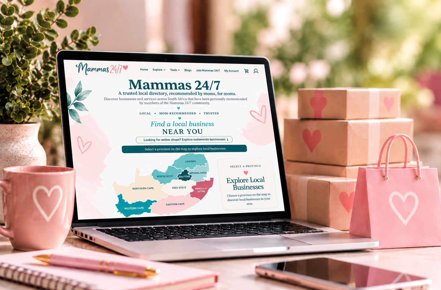 Mammas Directory website displayed on a laptop, surrounded by parcels and shopping accessories.